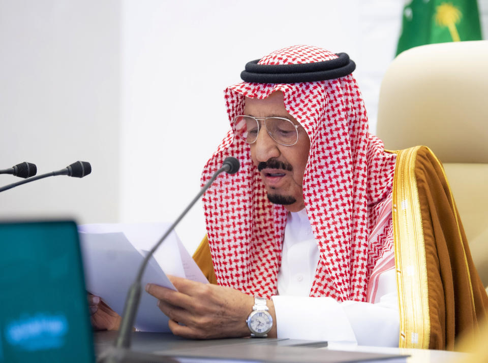 In this handout image provided by Saudi Royal Palace, Saudi King Salman gives his opening remarks at a virtual G20 summit hosted by Saudi Arabia and held over video conference amid the COVID-19 pandemic, in Riyadh, Saudi Arabia, Saturday, Nov. 21, 2020. (Bandar Aljaloud/Saudi Royal Palace via AP)