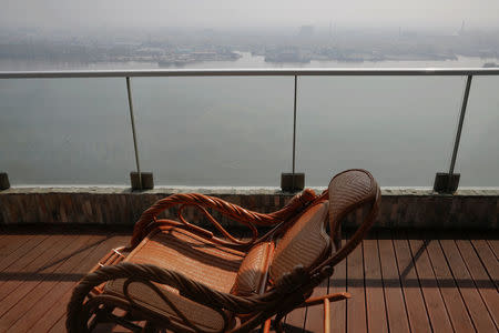 A rocking chair is placed on the balcony of a luxury apartment overlooking the North Korean town of Sinuiju, in Dandong, China's Liaoning province, March 30, 2017. REUTERS/Damir Sagolj