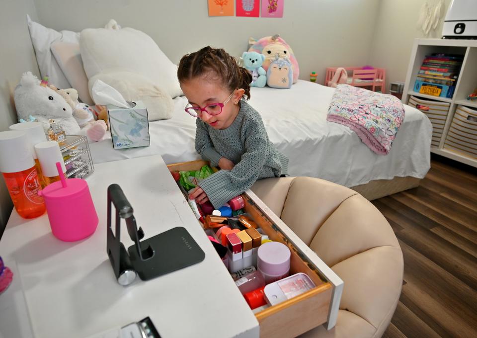 TikTok star Vitoria Bueno looks through her makeup drawer in her bedroom.