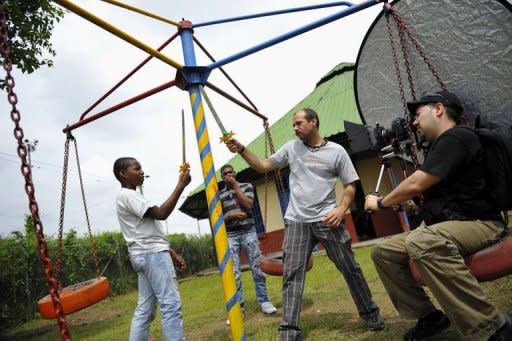 Colombian film director Oscar Hincapie (2-R) gives instructions to an actor during the shooting of his movie "Petecuy", in Cali, department of Valle del Cauca, Colombia on June 3. In Petecuy, one of the roughest neighborhoods in Cali, one of Colombia's most dangerous cities, life and art are intertwined