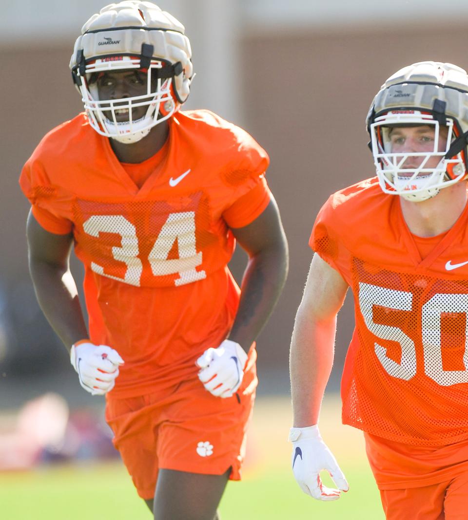 Clemson defensive end Armon Mason (34) runs with linebacker Fletcher Cothran (50) , right, during the second day of spring practice at the football Complex in Clemson, SC Tuesday, March 7, 2023.