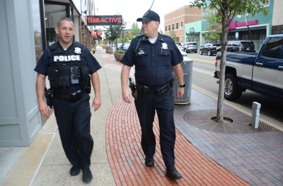 Officer Thomas Burke, left, and Corporal Joe Wilder walking the beat downtown.