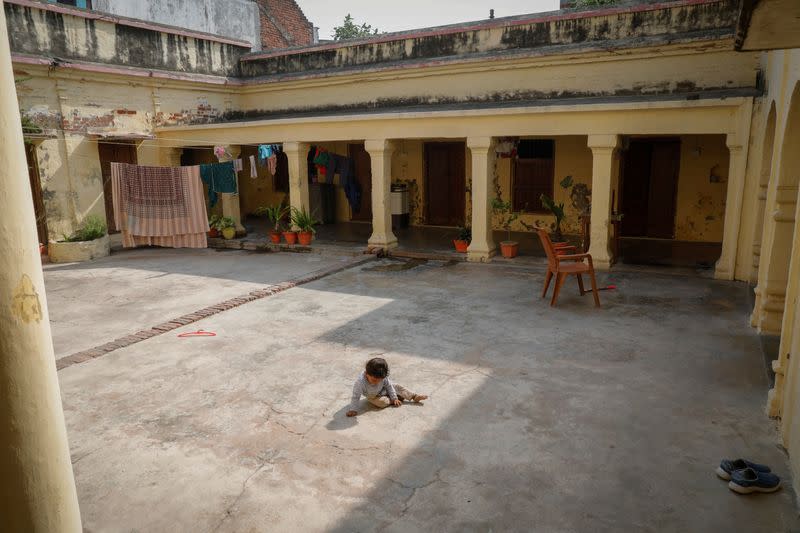 A child sits in the courtyard of the central office of India's main opposition Congress party in Raebareli