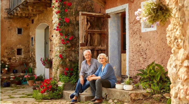 Older couple in front of an investment property