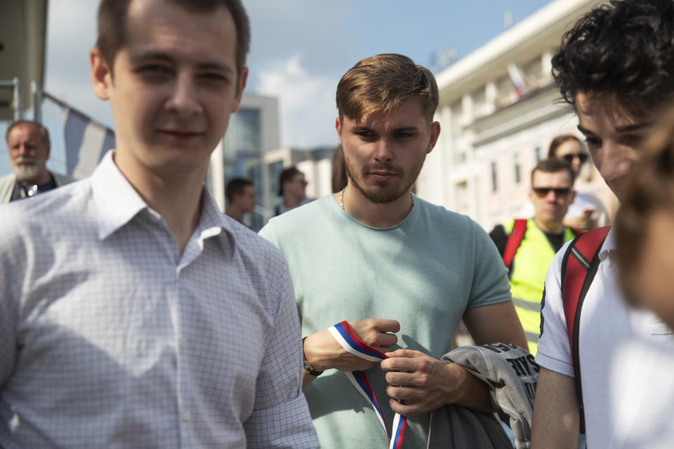 In this photo taken on Saturday, Aug. 31, 2019, Danil Denisov, center, and Artyom Abramov, left, members of the small, grassroots group Bessrochka arrive to take part in protest march in Moscow. Bessrochka, which loosely translates to “Protest Without End,” is a leaderless, nonviolent group that first emerged after a handful of protesters refused to leave Moscow’s Pushkin Square following street protests against a proposed pension reform a year ago. (AP Photo/Pavel Golovkin)