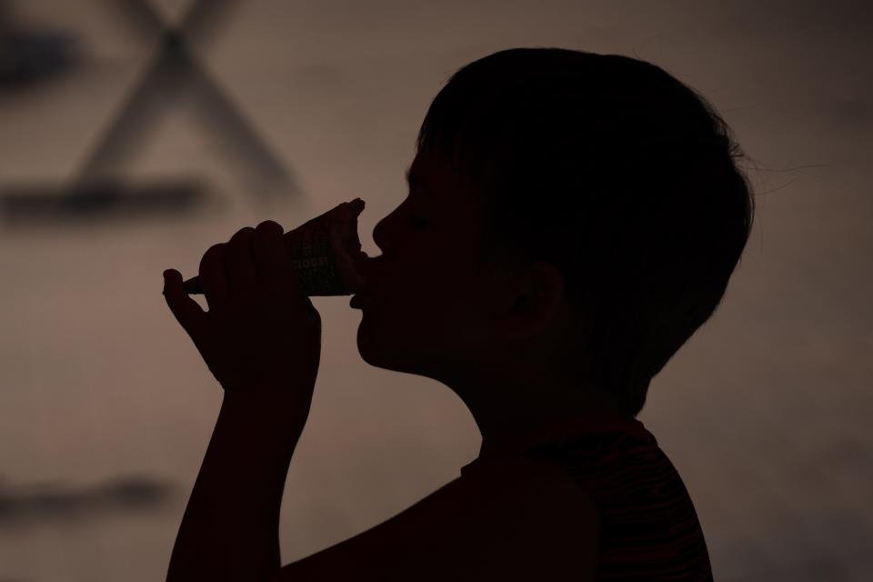 Remington Klibbe, 6, eats an ice cream cone on a hot day in downtown Fort Collins on July 17, 2023.