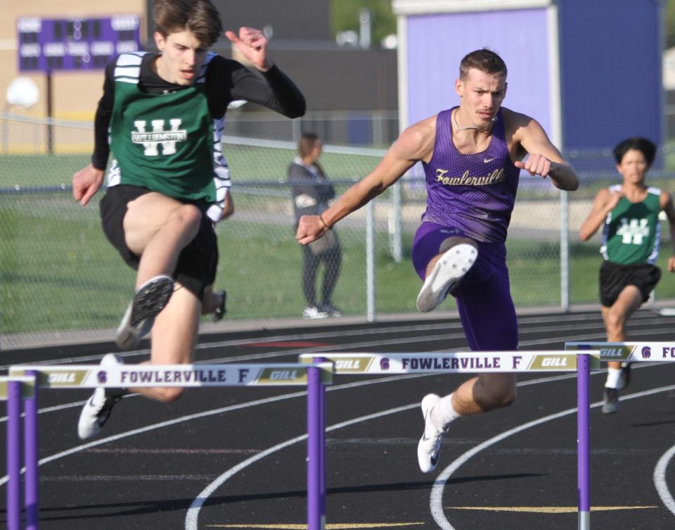 Fowlerville's Carl Neuman (right) won both hurdles races and was on two winning relays in a meet against Williamston on Tuesday, May 9, 2023.