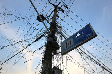 A sign board for a public toilet is seen attached to an electric pole in Guangfuli neighbourhood in Shanghai, China, March 28, 2016. REUTERS/Aly Song