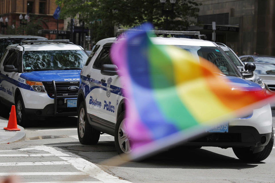 <p>A man waves a rainbow flag in front of two Boston Police vehicles outside a Pride Month block party in Boston, Massachusetts, U.S. June 12, 2016 the same day as the mass shooting at Orlando’s Pulse nightclub. (REUTERS/Brian Snyder) </p>