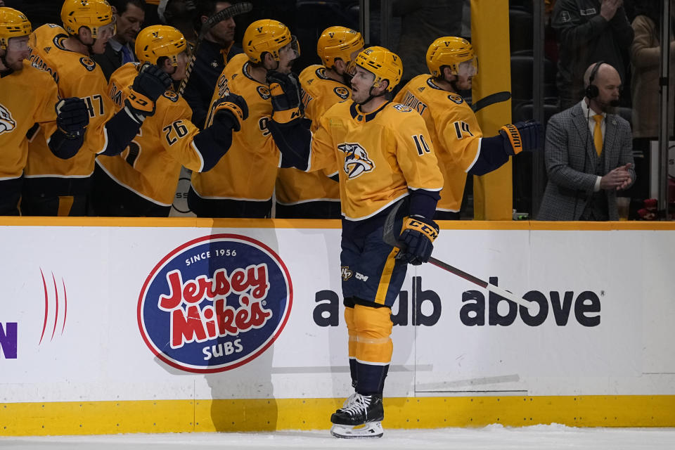 Nashville Predators center Colton Sissons (10) celebrates a goal with teammates during the first period of an NHL hockey game against the Calgary Flames, Thursday, Jan. 4, 2024, in Nashville, Tenn. (AP Photo/George Walker IV)