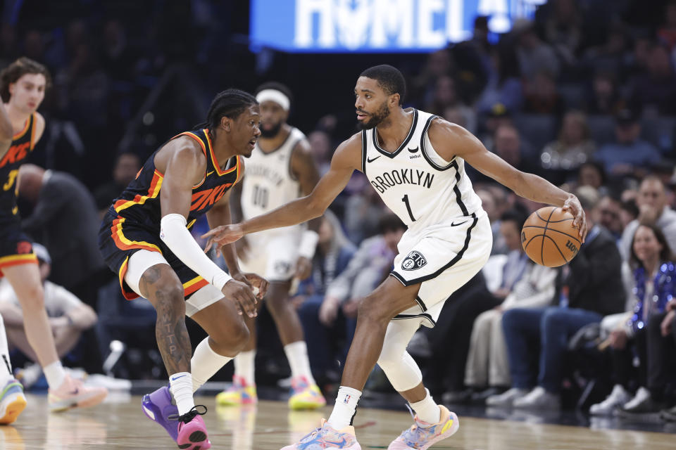 Dec 31, 2023; Oklahoma City, Oklahoma, USA; Brooklyn Nets forward Mikal Bridges (1) is defended by Oklahoma City Thunder forward Jalen Williams (8) on a play during the first quarter at Paycom Center. Mandatory Credit: Alonzo Adams-USA TODAY Sports