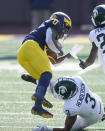 Michigan wide receiver Giles Jackson (0) is tackled by Michigan State safety Xavier Henderson (3) during the first half of an NCAA college football game, Saturday, Oct. 31, 2020, in Ann Arbor, Mich. (AP Photo/Carlos Osorio)