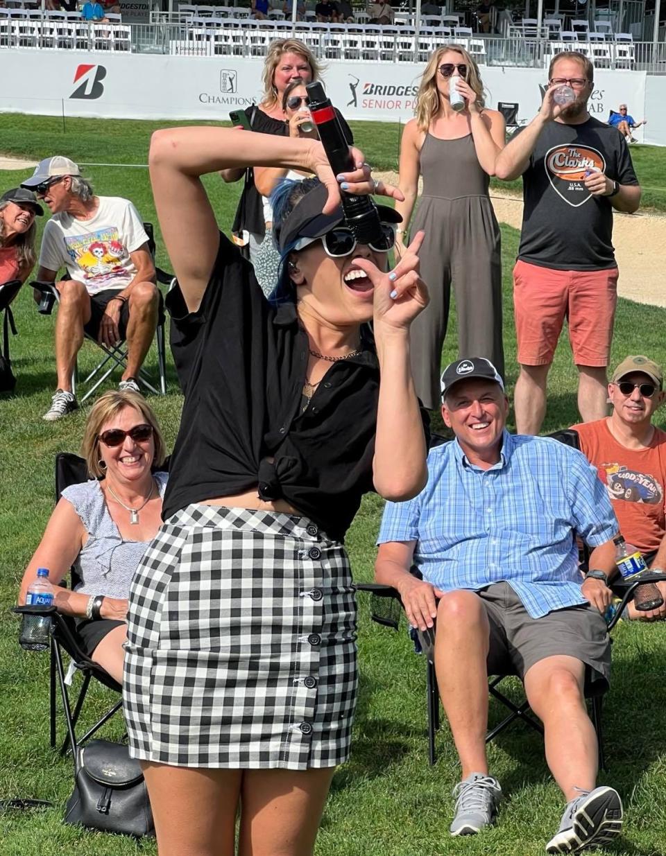 Jackie Popovec of The Vindys pretends has fun out in the audience during the rock band's recent show at Firestone Country Club in Akron.