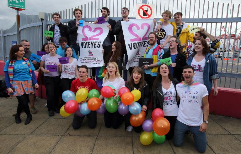 Irish nationals who arrived by ferry from Britain pose for a group picture at Dublin port in Ireland, on May 22, 2015, as they prepare to vote in a referendum on whether same-sex marriage should become legal