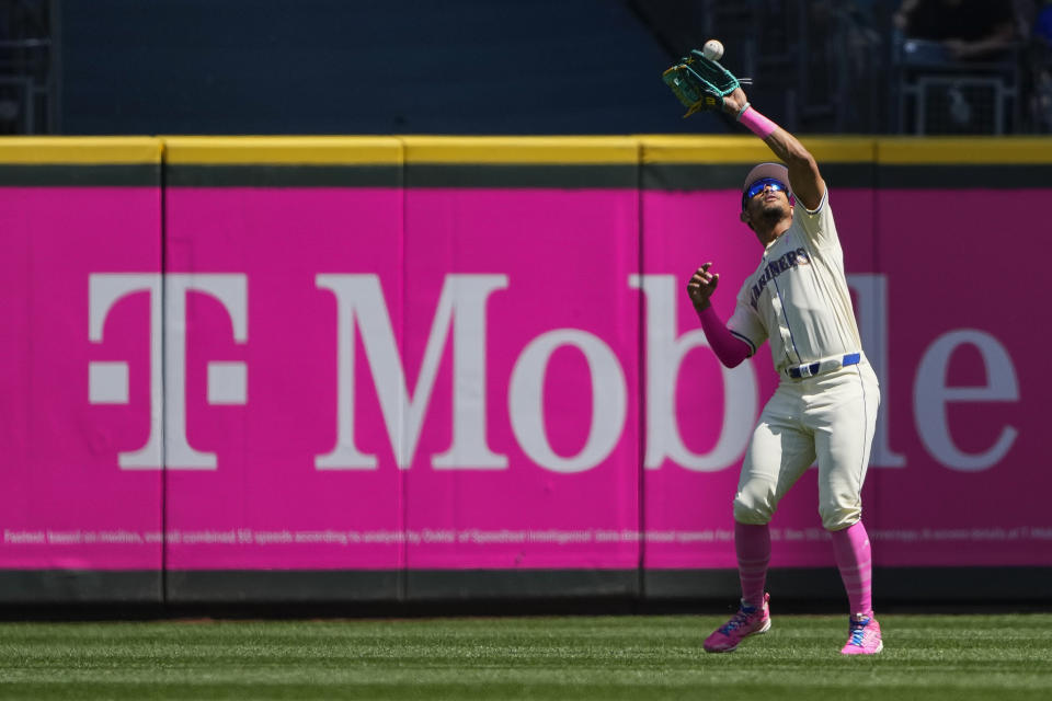 Seattle Mariners center fielder Julio Rodríguez catches a fly ball from Oakland Athletics' Tyler Nevin during the first inning of a baseball game Sunday, May 12, 2024, in Seattle. (AP Photo/Lindsey Wasson)