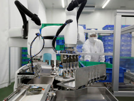 Kawasaki Heavy Industries' collaborative robot stacks rice balls at Delicious Cook &Co's food factory in Narashino, Japan, April 17, 2018. REUTERS/Toru Hanai