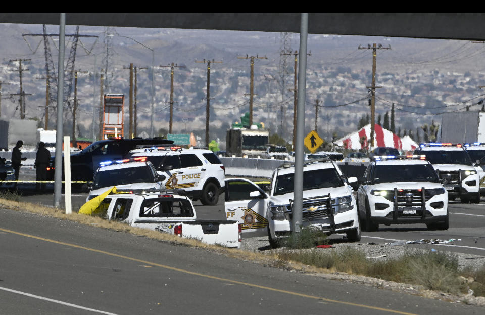 Law enforcement vehicles surrounded the vehicle driven by Anthony John Graziano, 45, following a gun battle with the man near Main Street on the 15 freeway in Victorville Tuesday, Sept. 27, 2022. 