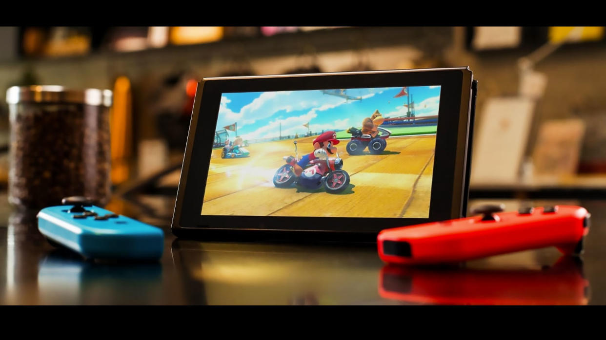  Best Nintendo Switch Deals - a product shot of the Nintendo Switch console and separate Joy-Cons playing Mario Kart 