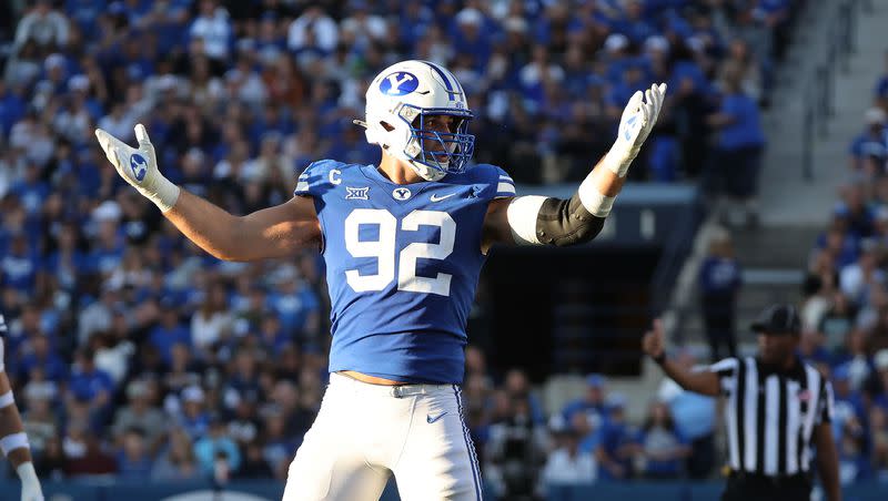 Brigham Young Cougars defensive end Tyler Batty (92) gestures to the fans to cheer louder against the Texas Tech Red Raiders in Provo on Saturday, Oct. 21, 2023. BYU won 27-14.