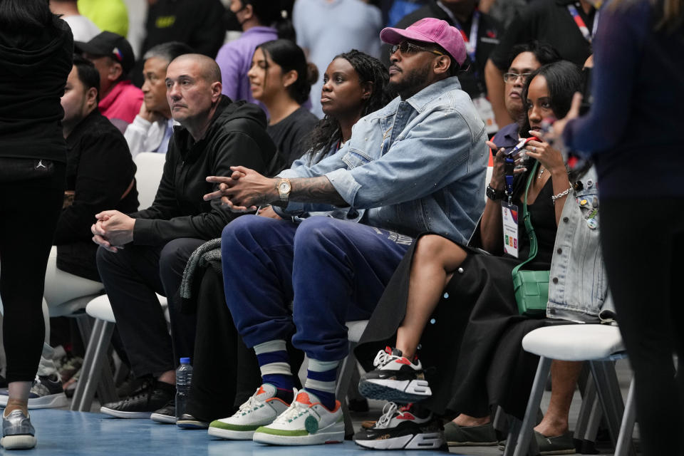 FIBA Global Ambassador Carmelo Anthony, second from right, watches the games against Philippines and Lebanon at the FIBA Basketball World Cup 2023 Asian Qualifiers at the Philippine Arena in Bulacan province, north of Manila, Philippines on Friday Feb. 24, 2023. (AP Photo/Aaron Favila)