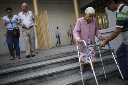 Elderly Venezuelan citizens depart after casting their votes at a polling station during the presidential election in Caracas, Venezuela, May 20, 2018. REUTERS/Carlos Garcia Rawlins