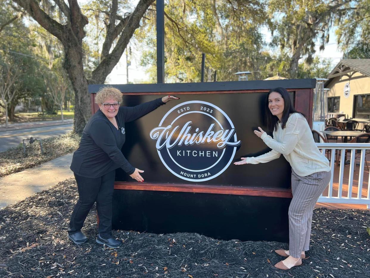 Edna Gonzalez, left, co-owns Whiskey Kitchen Mount Dora with her husband, Louie, is joined by Misty E. Sommer, Mount Dora's director of economic development.