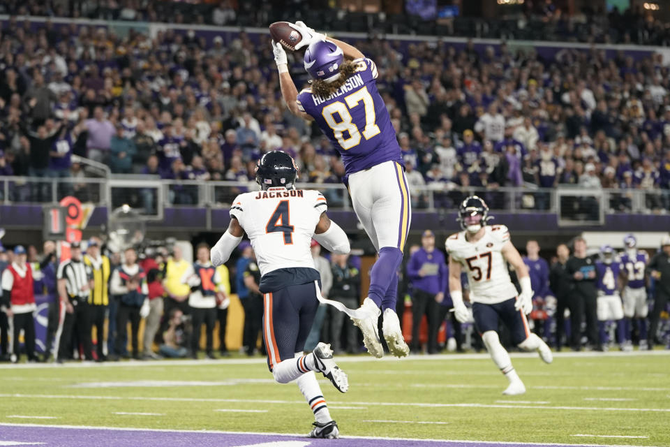 Minnesota Vikings tight end T.J. Hockenson (87) catches a 17-yard touchdown pass over Chicago Bears safety Eddie Jackson (4) during the second half of an NFL football game, Monday, Nov. 27, 2023, in Minneapolis. (AP Photo/Abbie Parr)