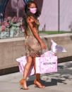 <p>Christina Milian leaves the Pretty Little Thing showroom with a handful of bags on Friday in West Hollywood.</p>