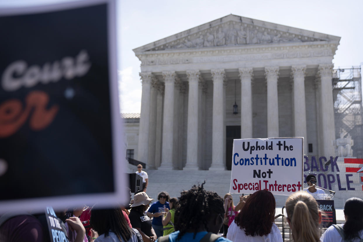 Demonstrators gather outside the Supreme Court on Friday.