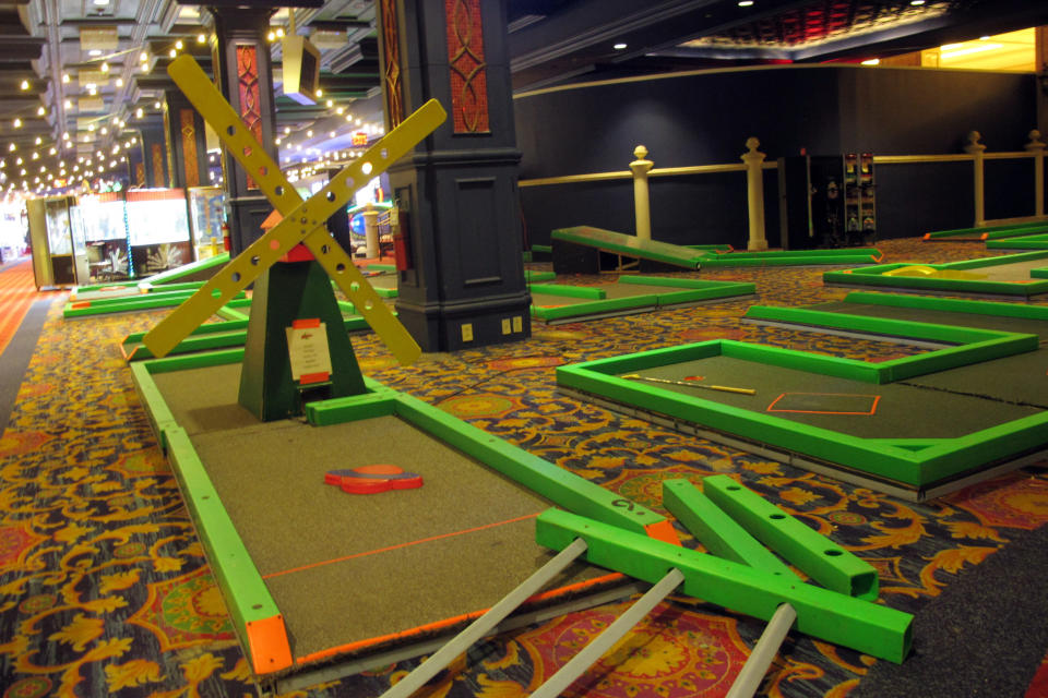 A day-glo mini-golf game sits inside the soon-to-open Lucky Snake arcade Wednesday, April 21, 2021, at the former Showboat casino in Atlantic City, N.J. Philadelphia developer Bart Blatstein is spending nearly $130 million on attractions at the former Atlantic City casino including an indoor water park; a retractible domed concert hall, a beer garden and a Boardwalk sun deck to increase family entertainment options in Atlantic City. (AP Photo/Wayne Parry)