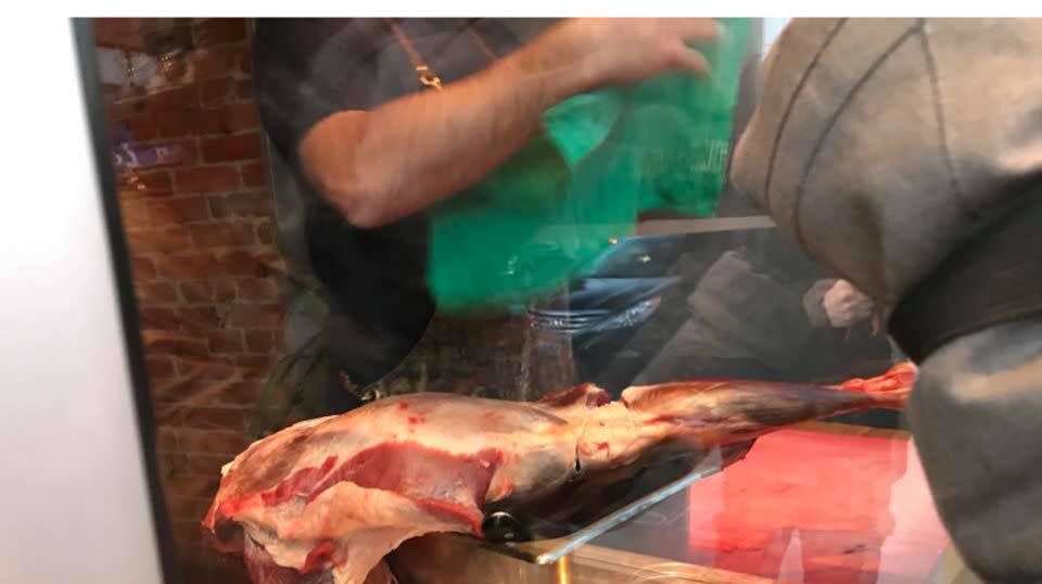 Mr Hunter could be seen slicing the large cut of meat in plain view of those outside. Source: Facebook/Marni Jill Ugar