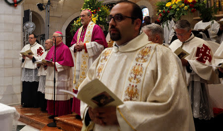 The acting Latin Patriarch of Jerusalem Pierbattista Pizzaballa leads a mass at the Church of the Nativity on Christmas eve, in Bethlehem, in the Israeli-occupied West Bank December 24, 2018. REUTERS/Raneen Sawafta