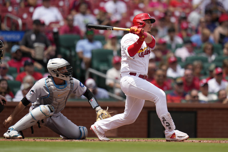 St. Louis Cardinals' Nolan Gorman, right, follows through on a three-run home run as Miami Marlins catcher Jacob Stallings, left, watches during the first inning of a baseball game Wednesday, July 19, 2023, in St. Louis. (AP Photo/Jeff Roberson)