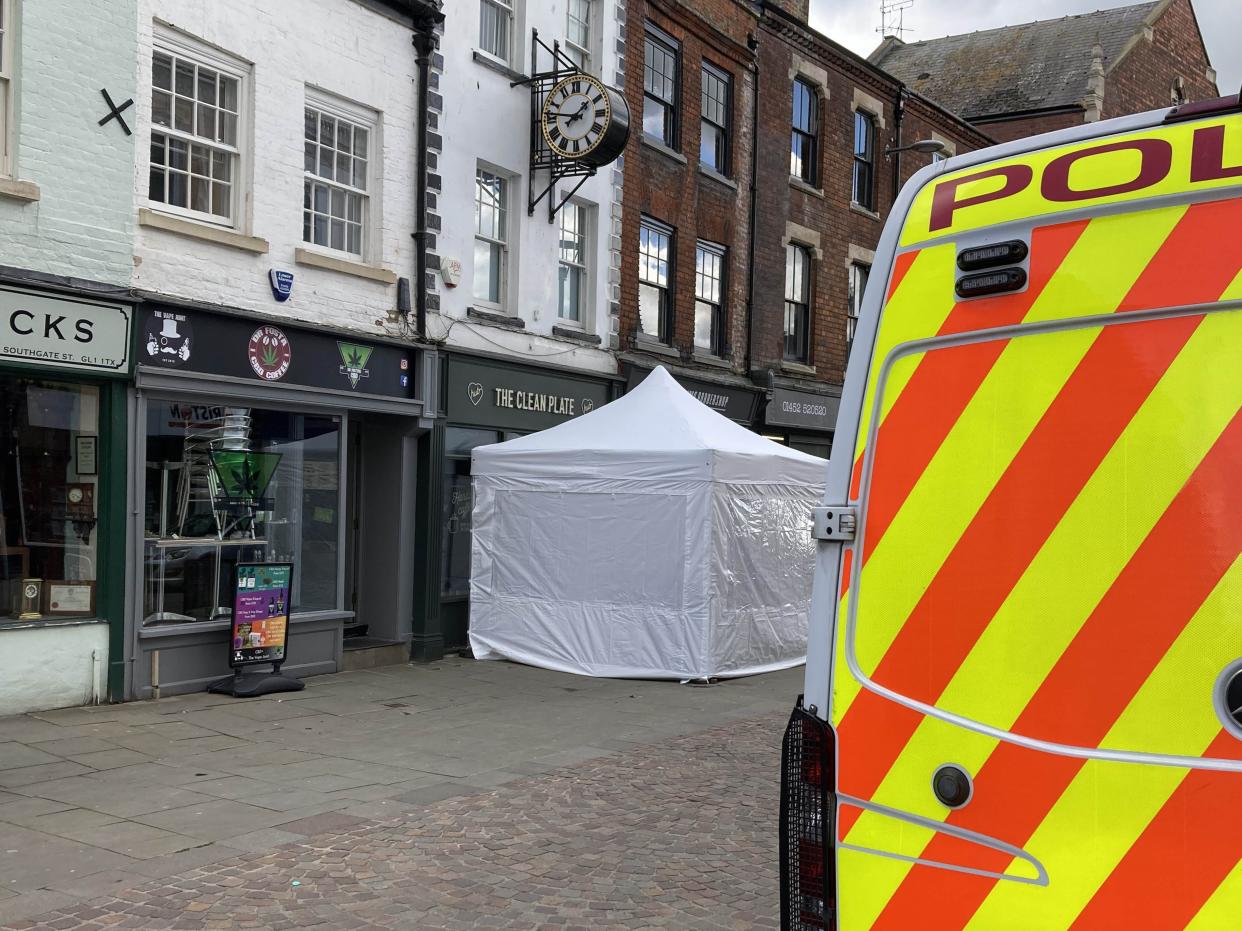<p>A police tent outside The Clean Plate cafe in Southgate Street, Gloucester</p> (PA)