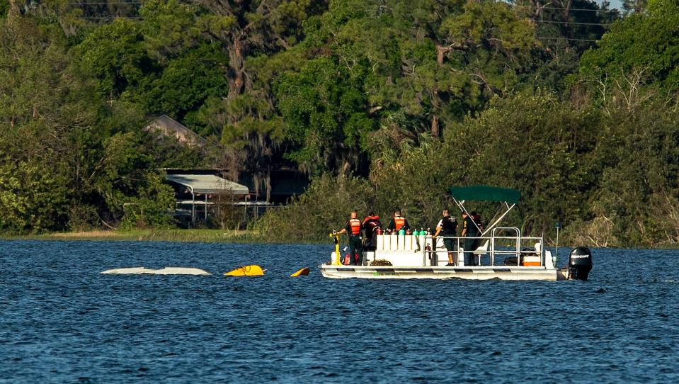Polk County Sheriff Underwater Search & Recovery Team search the area around a partially submerged aircraft that crashed into Lake Hartridge after colliding with another aircraft this afternoon in Winter Haven Fl  Tuesday March 7,2023.There has been one confirmed fatality and divers are searching for the other plane which sank.Ernst Peters/The Ledger