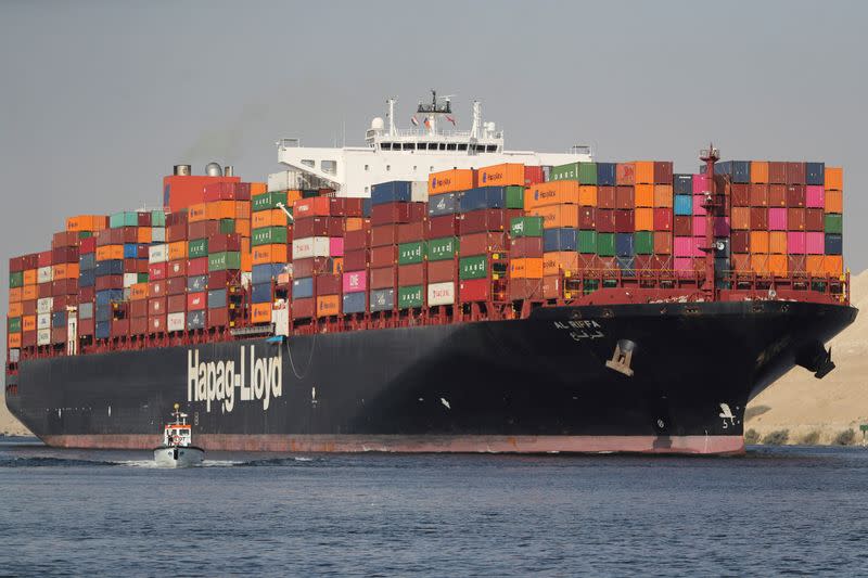 FILE PHOTO: Shipping containers pass through the Suez Canal in Ismailia