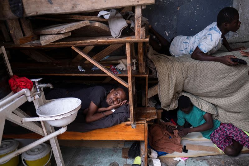 People shelter inside a school after their settlement was burned down by gangs, in Port-au-Prince