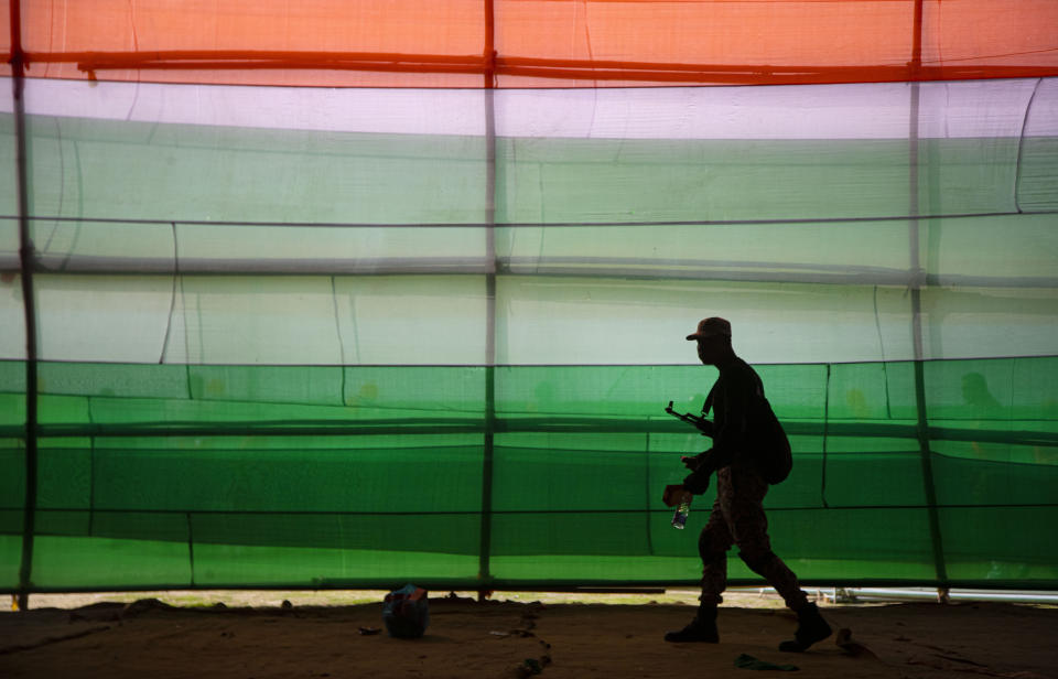 An Assam smart police commando walks after participating in a parade to mark Republic Day in Gauhati, India, Sunday, Jan. 26, 2020. Sunday's event marks the anniversary of the country's democratic constitution taking force in 1950. (AP Photo/Anupam Nath)