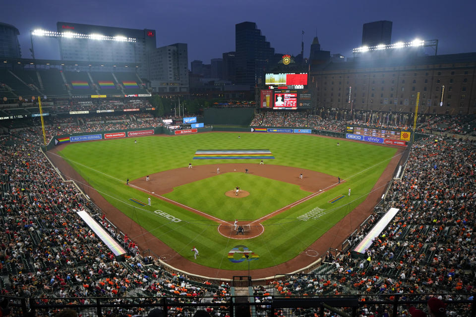 A crowd watches the fifth inning of a baseball game between the Baltimore Orioles and the Cincinnati Reds during Pride Night, Wednesday, June 28, 2023, in Baltimore. (AP Photo/Julio Cortez)