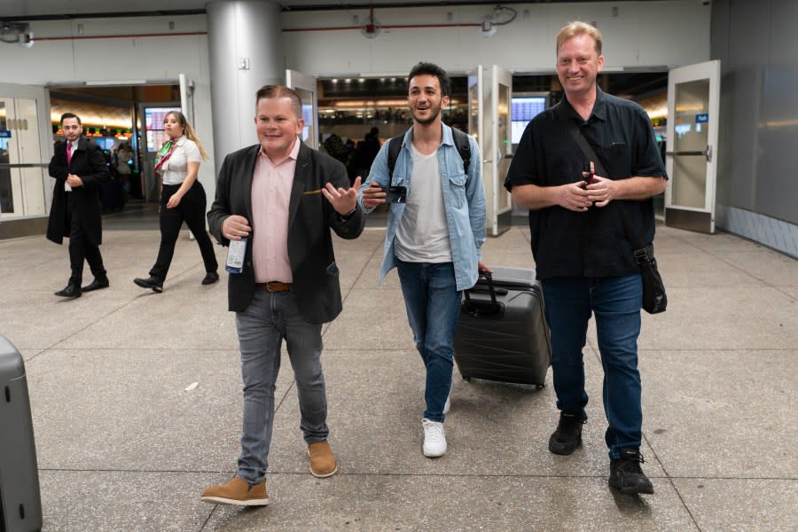 Michael White, a Navy veteran who was jailed in Iran for several years on spying charges, right, Michael’s former fellow prisoner and Iranian political activist Mahdi Vatankhah, center, and Jonathan Franks, a consultant in the U.S. for families of American hostages and detainees, leave a terminal at the Los Angeles International Airport in Los Angeles, Thursday, June 1, 2023. Vatankhah, while in custody and after his release, helped White by providing White’s mother with crucial, firsthand accounts about her son’s status in prison and by passing along letters White had written while he was locked up. Once freed, White did not forget. He pushed successfully this year for Vatankhah’s admission to the United States, allowing the men to be reunited last spring, something neither could have envisioned when they first met in prison years earlier. (AP Photo/Jae C. Hong)