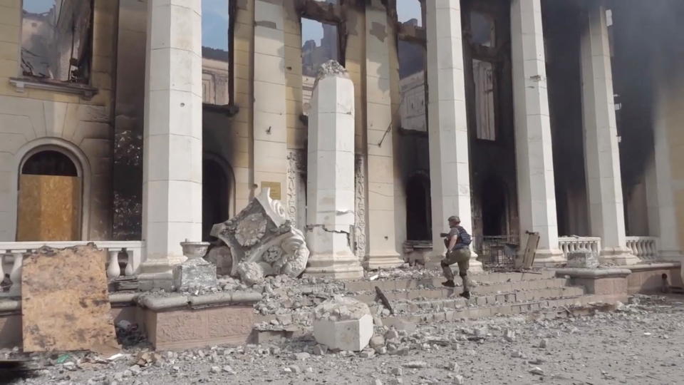 A police officer walks near a collapsed pillar at the heavily damaged centre for student and youth extracurricular activities, following Russian army artillery strikes in Lysychansk, Ukraine June 5, 2022 in this still image taken from handout video. Filmed June 5, 2022. National Police of Ukraine/Handout via REUTERS THIS IMAGE HAS BEEN SUPPLIED BY A THIRD PARTY. MANDATORY CREDIT