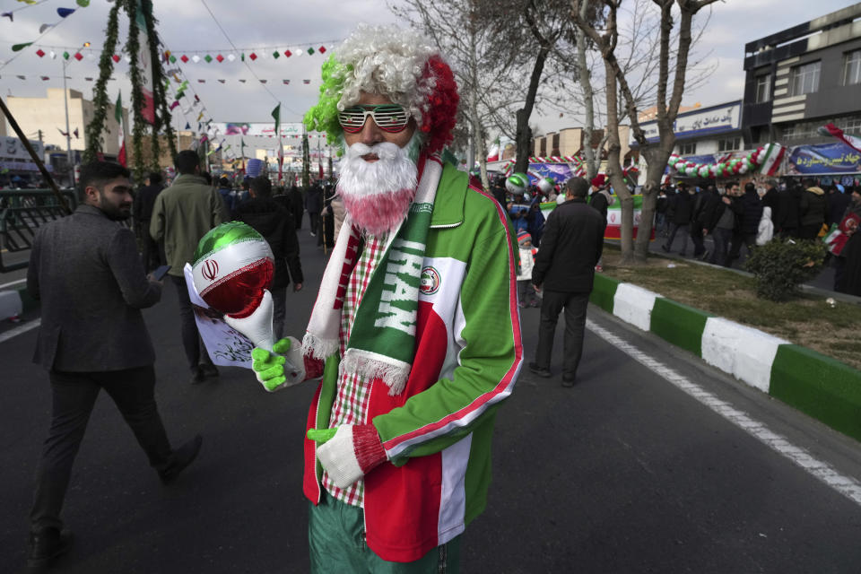 A man wears jacket in the colors of Iranian flag as he attends the annual rally commemorating Iran's 1979 Islamic Revolution, in Tehran, Iran, Saturday, Feb. 11, 2023. Iran on Saturday celebrated the 44th anniversary of the 1979 Islamic Revolution amid nationwide anti-government protests and heightened tensions with the West. (AP Photo/Vahid Salemi)