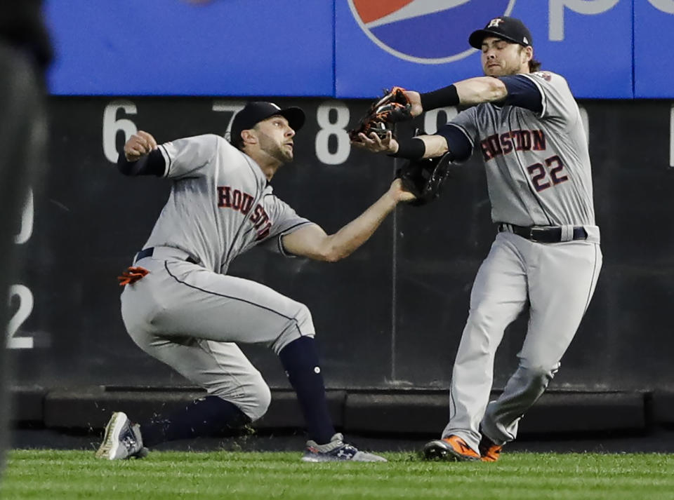 Houston Astros right fielder Josh Reddick (22) and center fielder Jake Marisnick collide as Reddick makes the catch for the out on New York Yankees' Austin Romine to end the fifth inning of a baseball game Saturday, June 22, 2019, in New York. (AP Photo/Frank Franklin II)