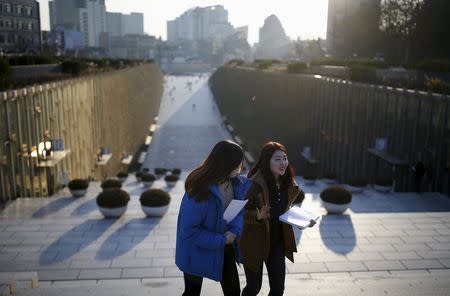 University students talk as they leave Ewha Campus Complex of Ewha Woman's University in Seoul, South Korea, November 30, 2015. Picture taken on November 30, 2015. REUTERS/Kim Hong-Ji
