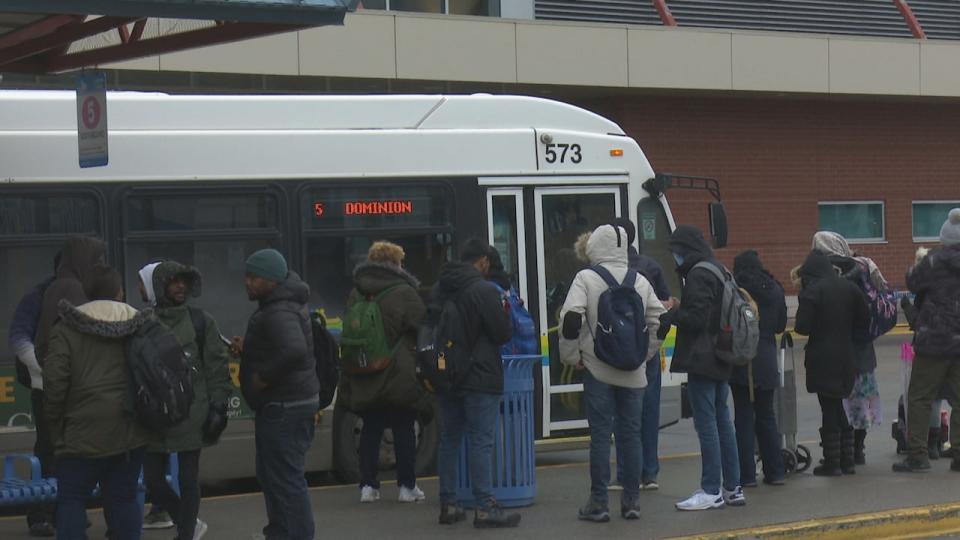 Riders of Transit Windsor's Dominion bus line up at the downtown Windsor terminal.