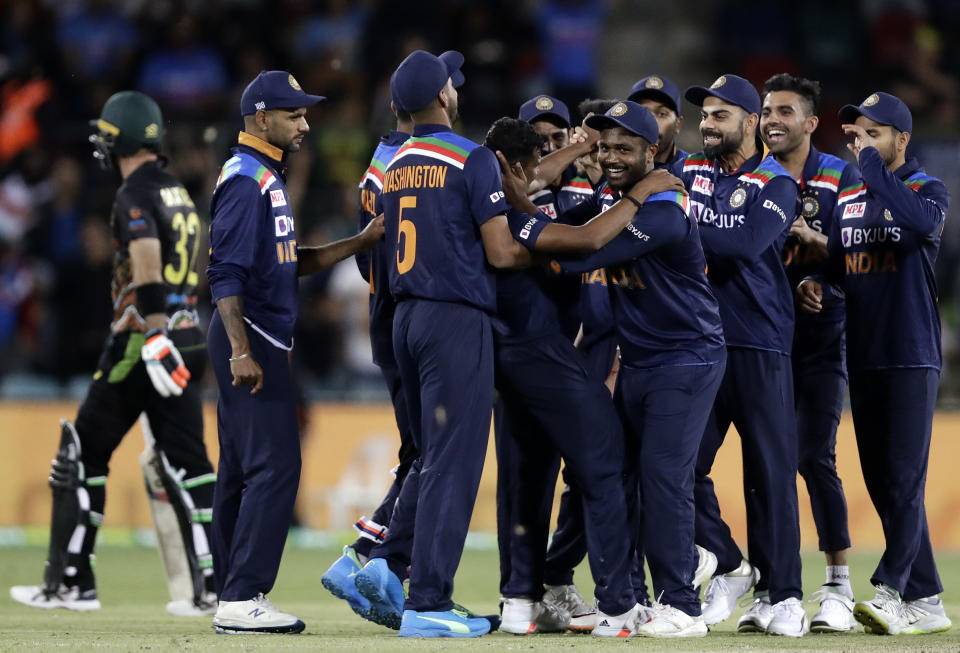 Indian teammates celebrate the wicket of Australia's Glenn Maxwell during their T20 international cricket match at Manuka Oval, in Canberra, Australia, Friday, Dec 4, 2020. (AP Photo/Mark Baker)