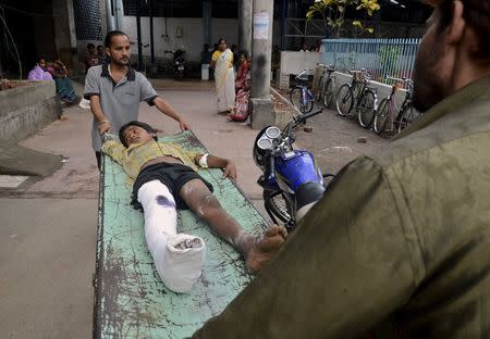 An injured boy is taken to a ward inside a hospital after an earthquake in Siliguri, India, April 25, 2015. REUTERS/Stringer