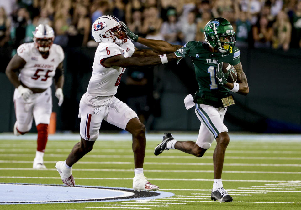Tulane wide receiver Dontae Fleming (1) stiff-arms South Alabama cornerback Ricky Fletcher (6) during the second quarter of an NCAA college football game in New Orleans, Saturday, Sept. 2, 2023. (AP Photo/Derick Hingle)