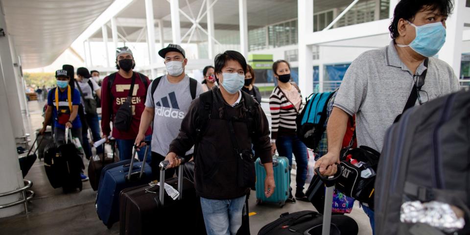 FILE PHOTO: Repatriated Overseas Filipino Workers or OFWs arrive at an airport after being allowed to go home following weeks of quarantine amid the spread of the coronavirus disease (COVID-19), in Pasay City, Metro Manila, Philippines May 26, 2020. REUTERS/Eloisa Lopez