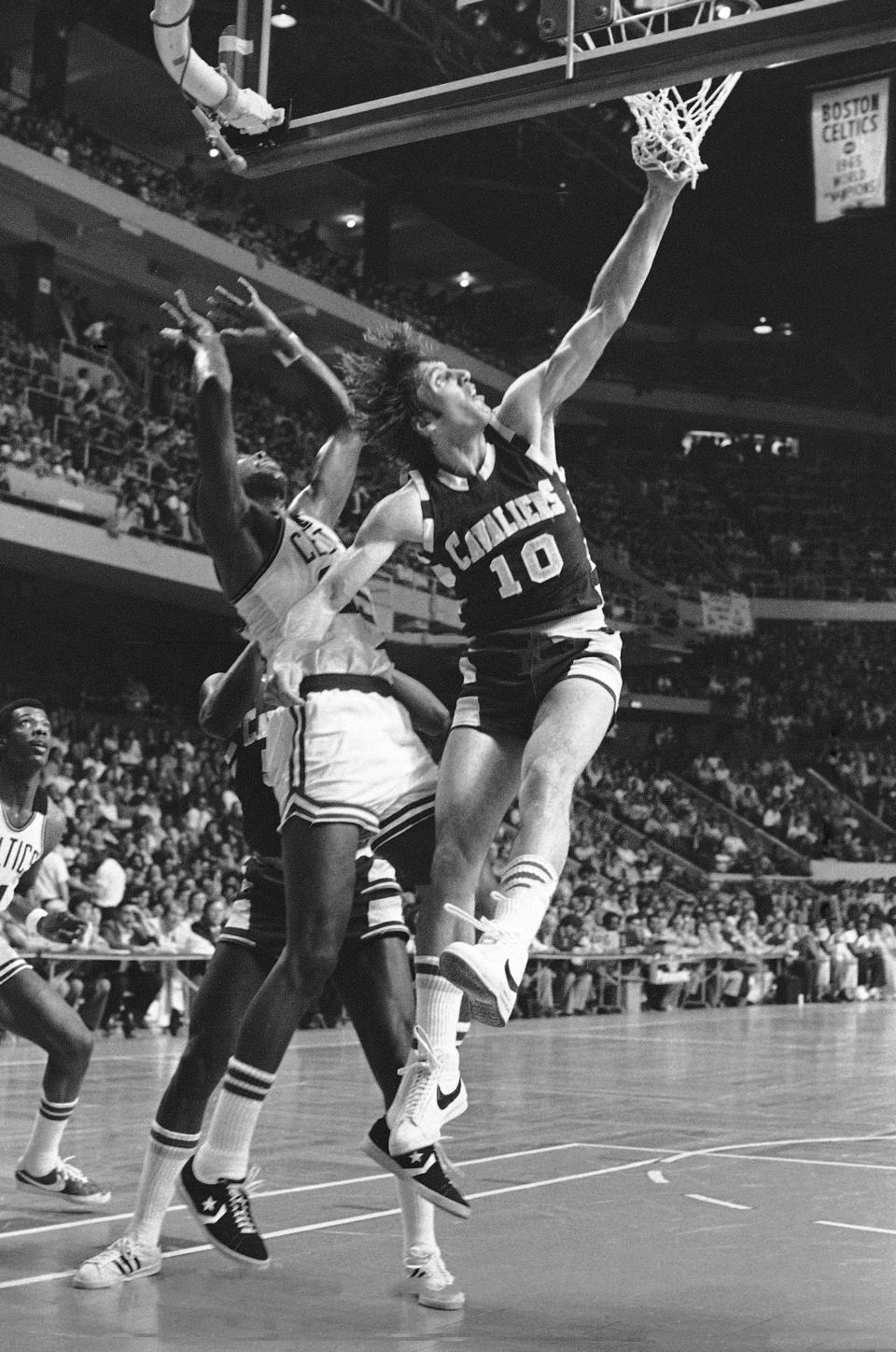 Cavaliers forward Dick Snyder scores a first-quarter basket while defended by Celtics forward Pal Silas in the NBA's Eastern Conference finals, Thursday, May 6, 1976, at Boston Garden.